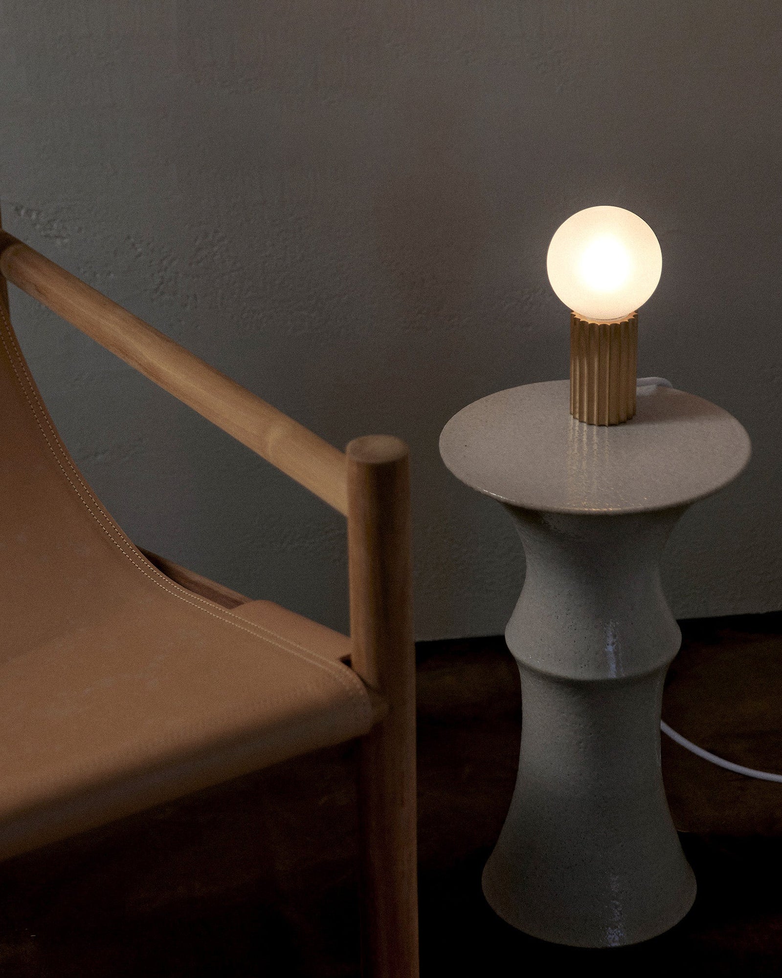 Attalos brass and glass table lamp on a coffee table